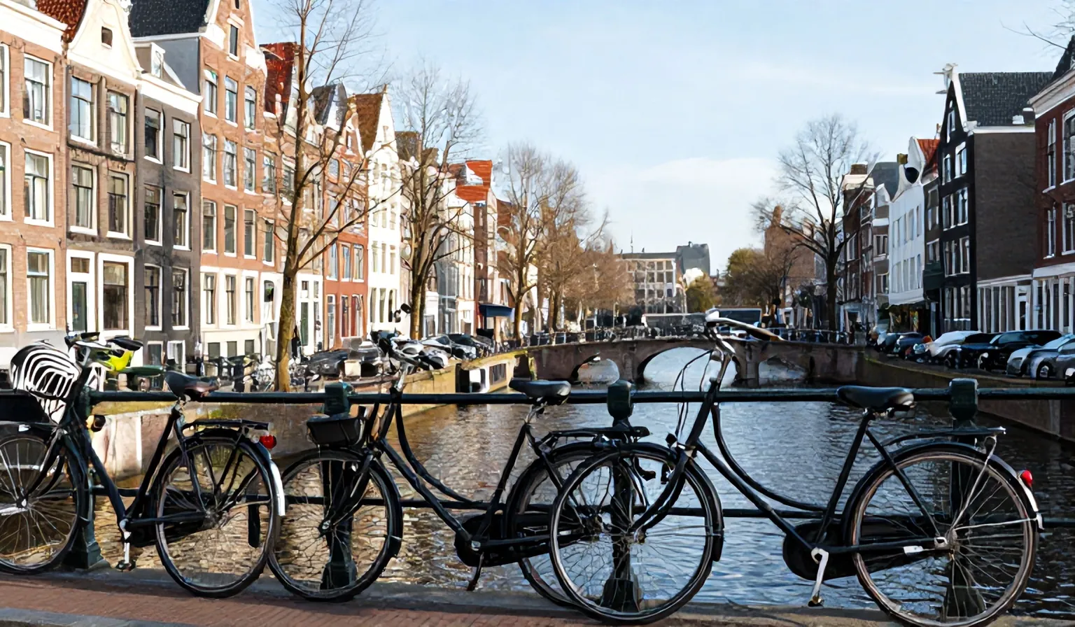 Black Dutch bikes parked along a canal with narrow canal houses