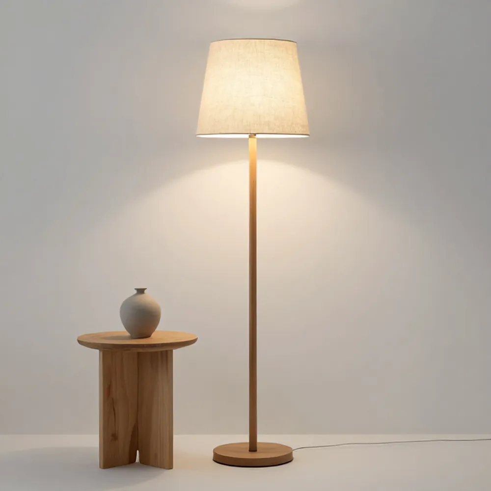Floor lamp with a pleated linen shade and an oak stem